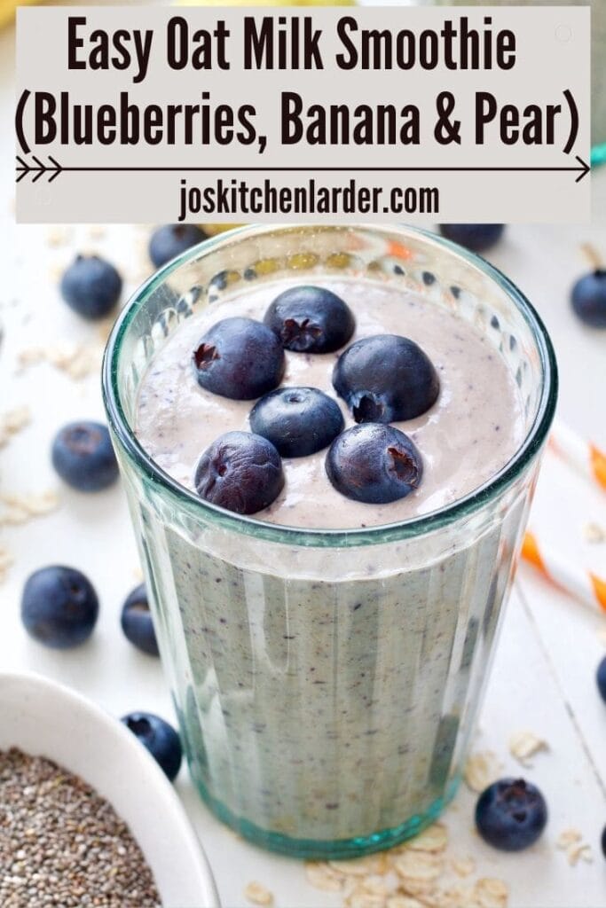 Glass filled with smoothie with fresh blueberries on top.