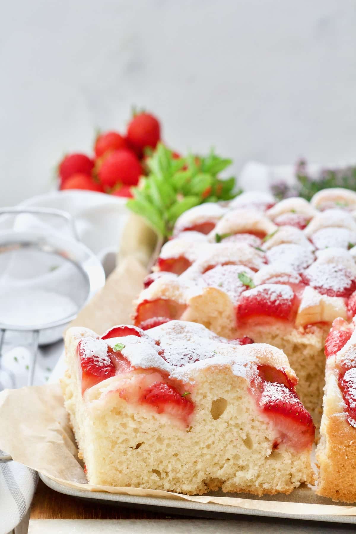 Slice of strawberry cake in a tin.