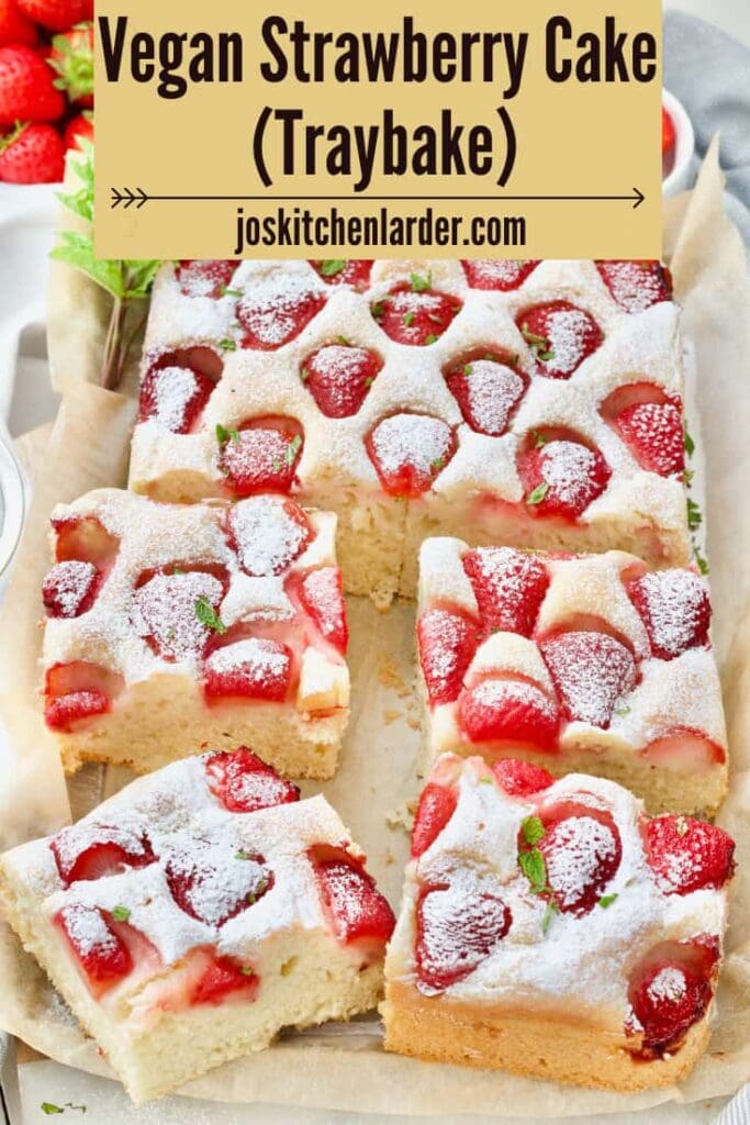 Strawberry traybake with four large portions cut.
