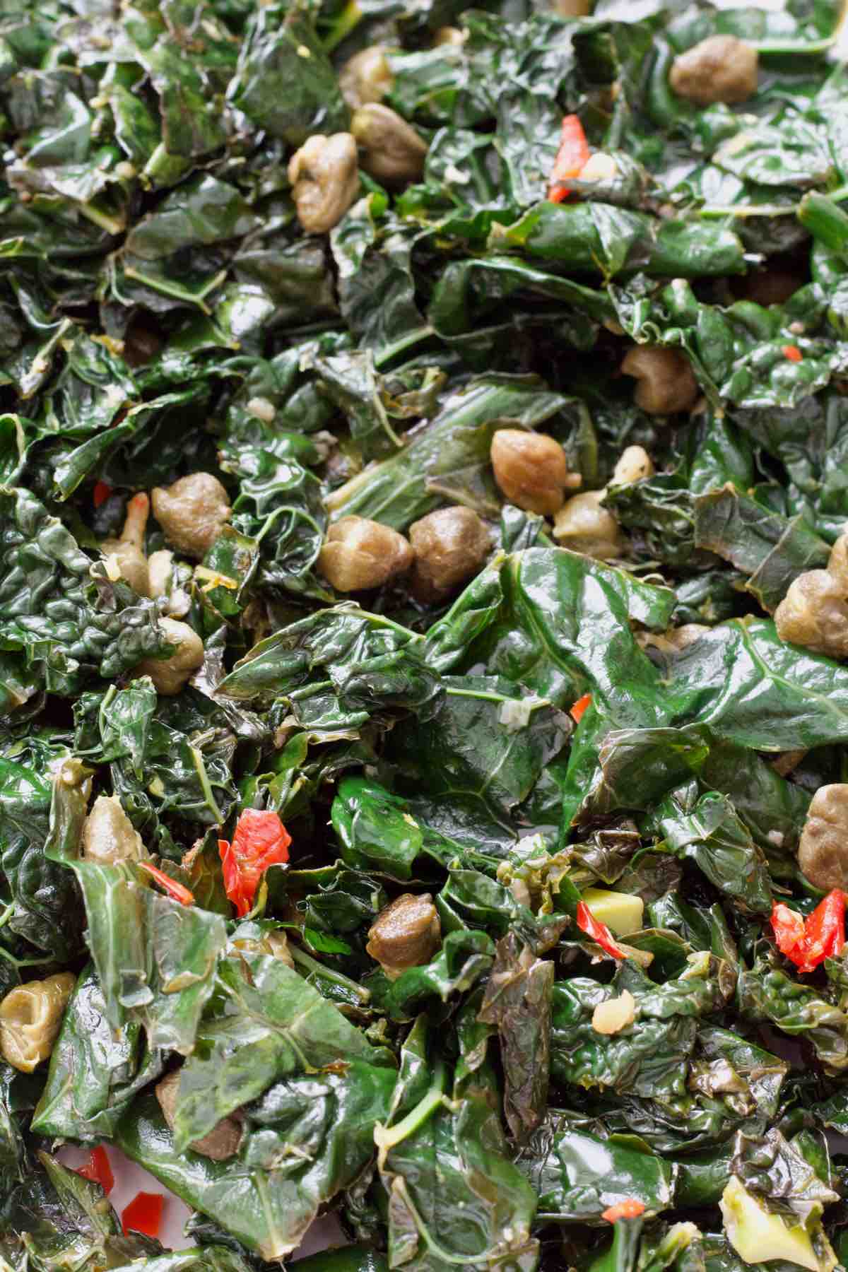 Stir fried cavolo nero with visible chilli and capers.
