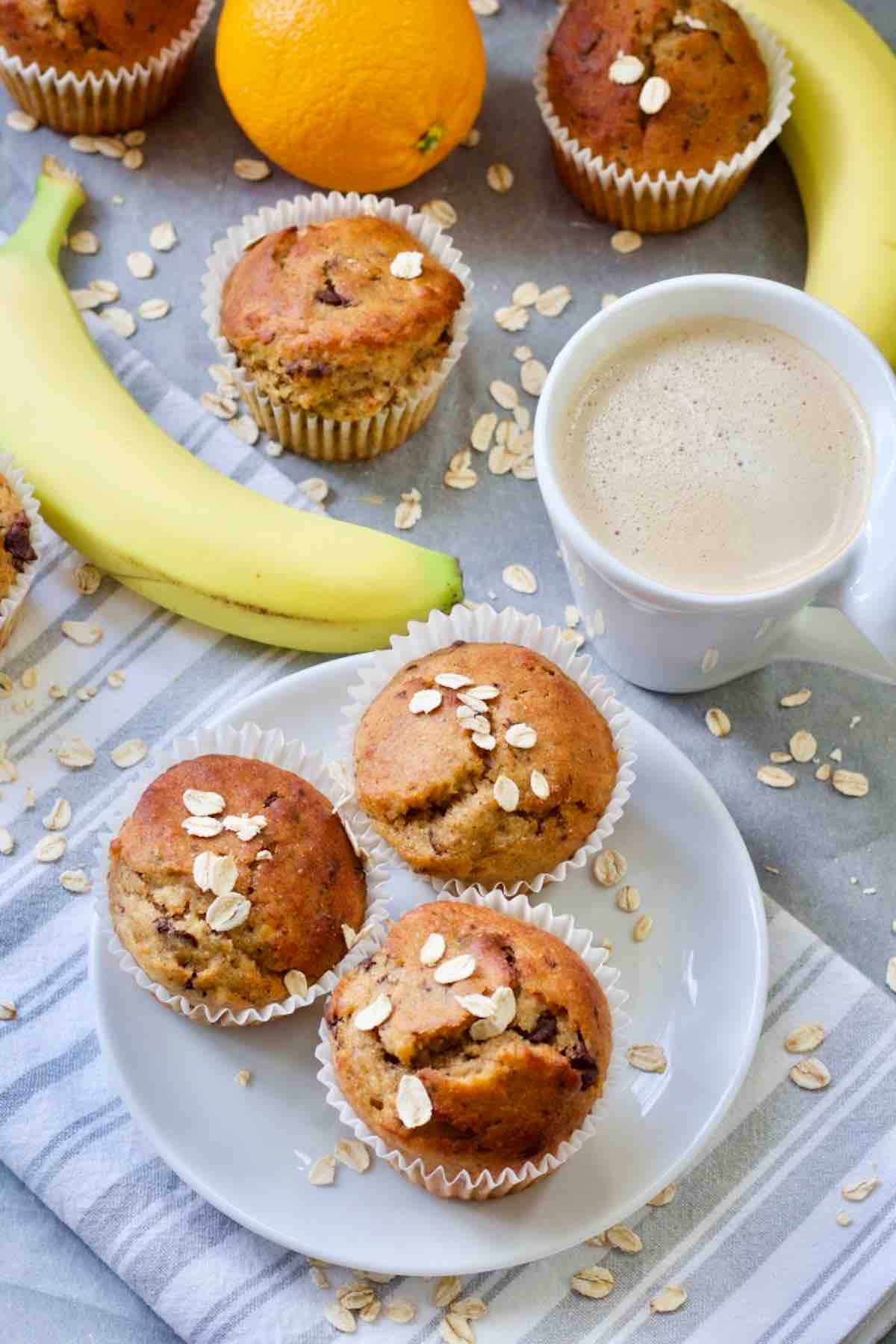 Healthy banana muffins on a plate, coffee, bananas, oats.
