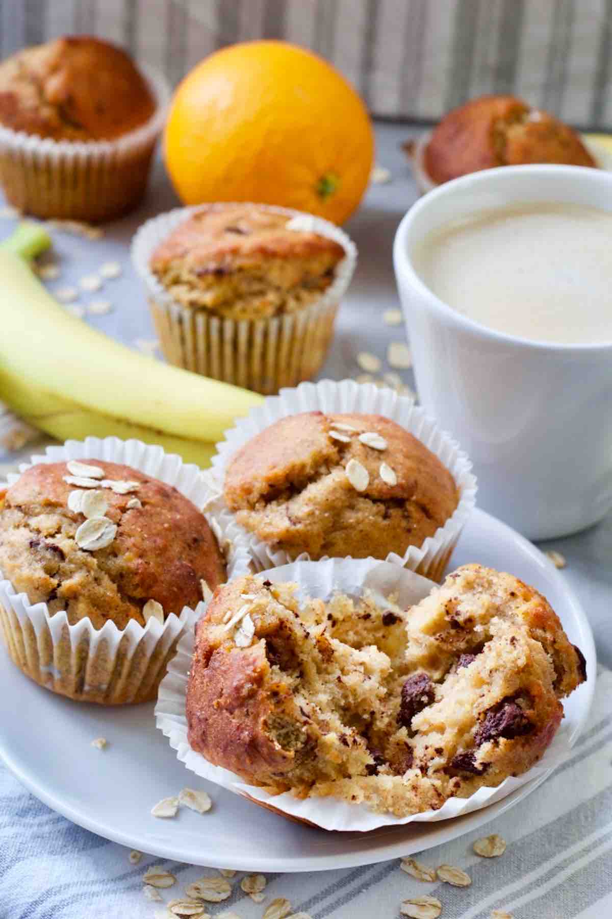Banana muffins on a plate, one torn in half.