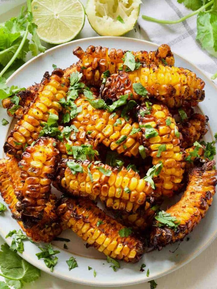 Plate with corn ribs garnished with fresh coriander.
