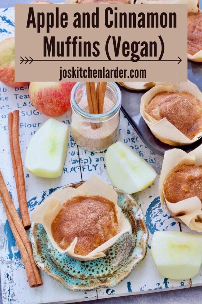 Apple and cinnamon muffins amongst apples and cinnamon sticks.