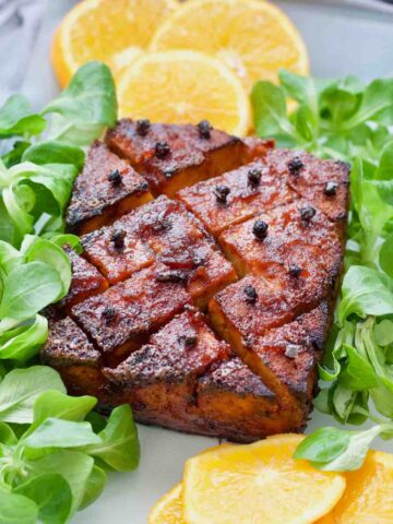 Orange glazed tofu roast with lettuce and orange slices.