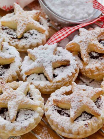 Puff pastry mince pies dusted with icing sugar.