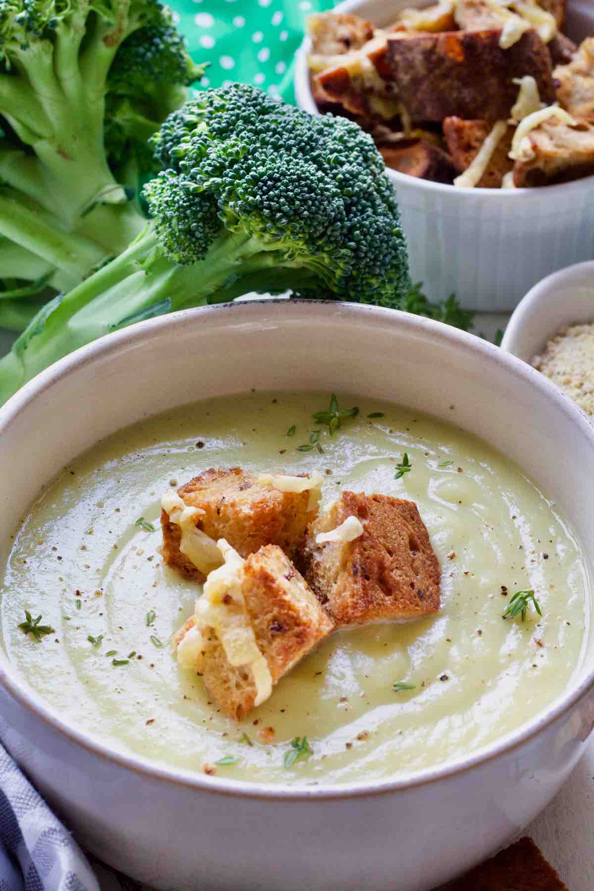 Broccoli soup in a bowl served with croutons.