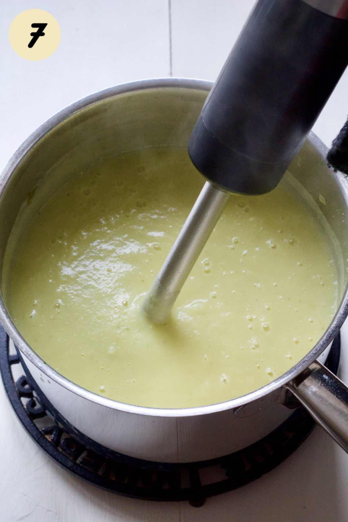 Pureeing soup with hand blender.