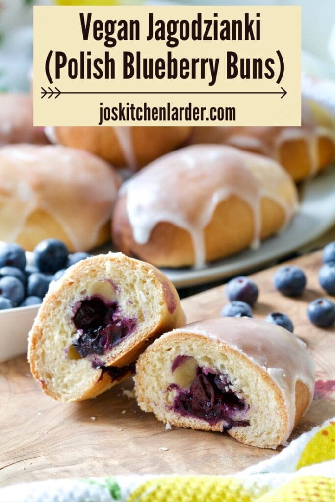 Blueberry bun cut in half with whole buns behind.