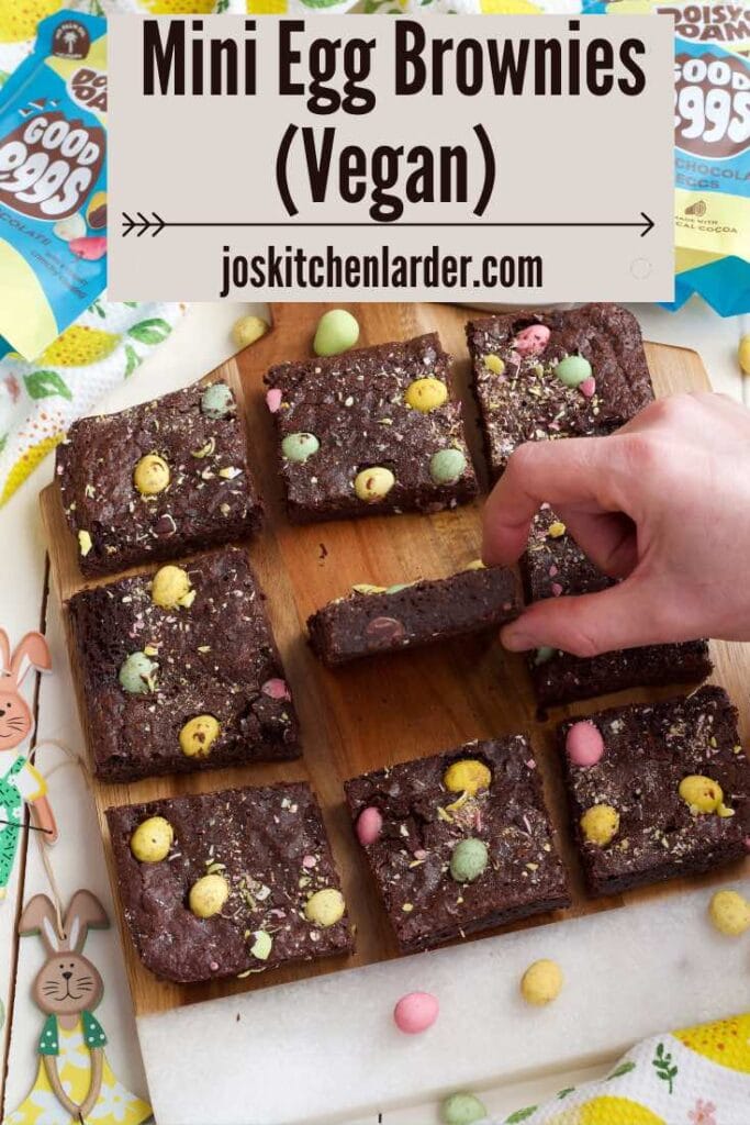 Hand holding a brownie to show how fudgy it is.