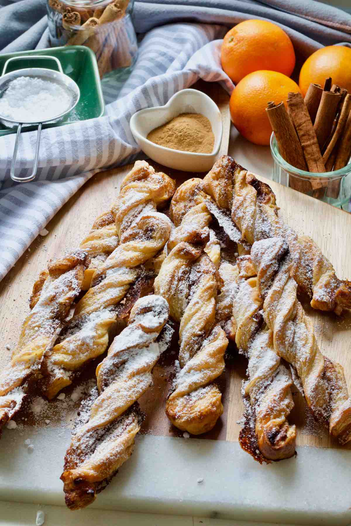 Puff pastry cinnamon twists on the board.