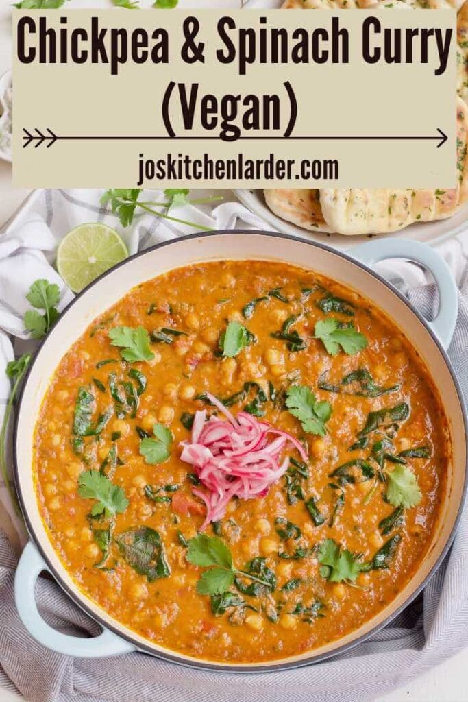 Pan with finished curry, condiments & naan breads.