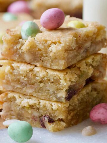 Close up of a stack of three mini egg blondies.