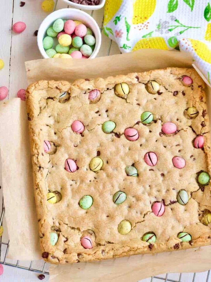 Mini egg cookie bars on a cooling rack before cutting.
