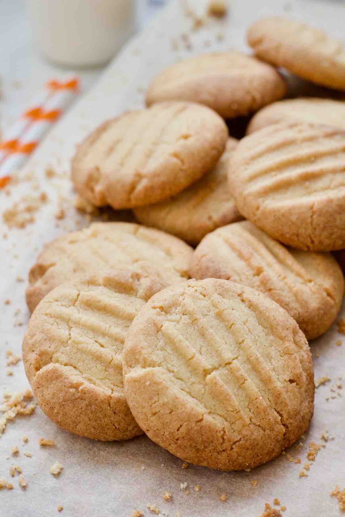 Pile of fork biscuits with crumbs around.