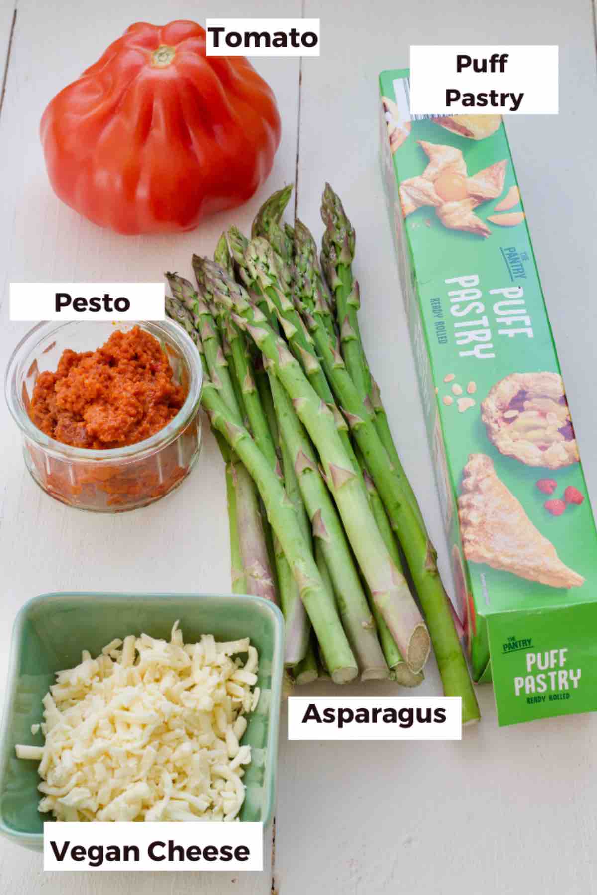 Ingredients for making tomato and asparagus puff pastry bundles.