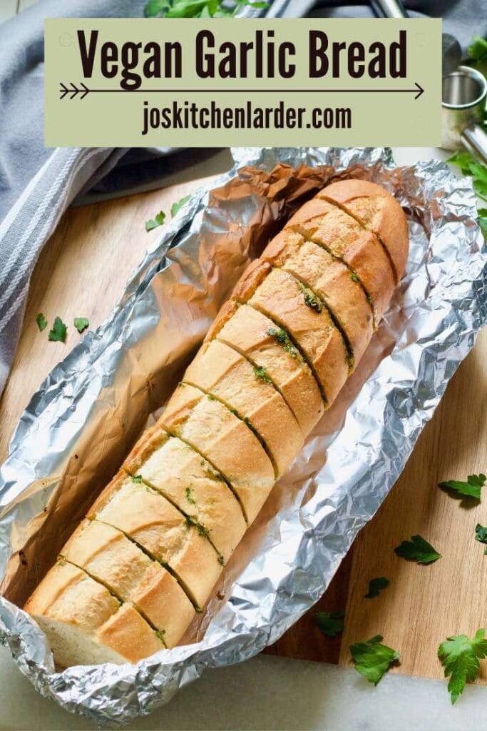 Baked vegan garlic bread resting in a foil parcel.