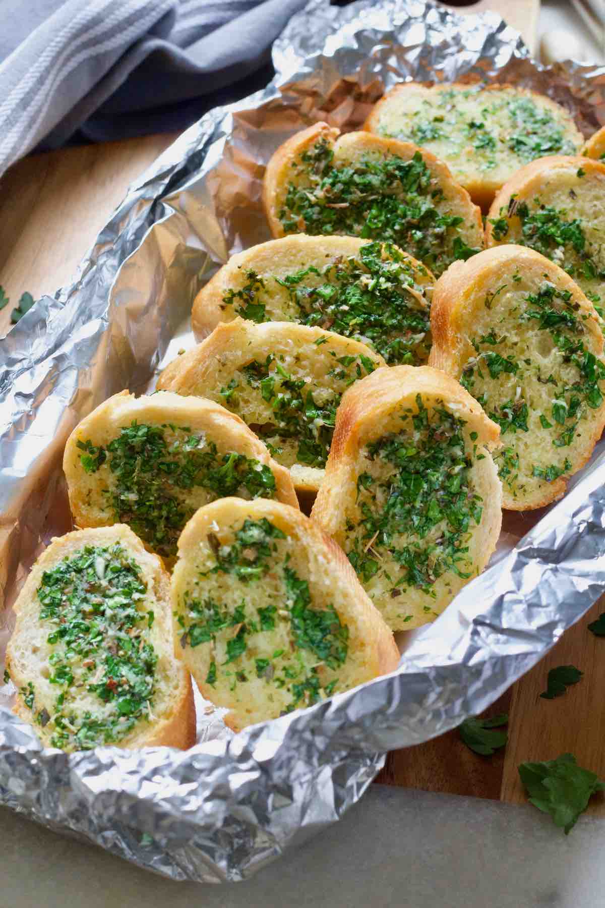 Vegan garlic bread slices in a foil parcel.