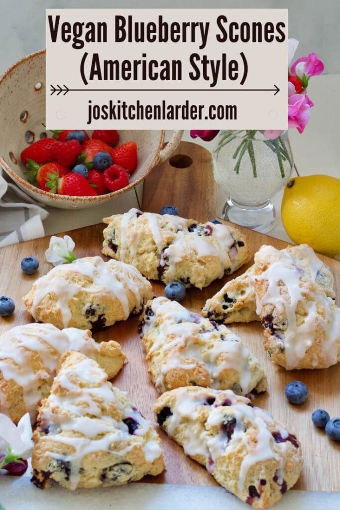 Blueberry scones, berries in a colander and sweet peas in a vase.