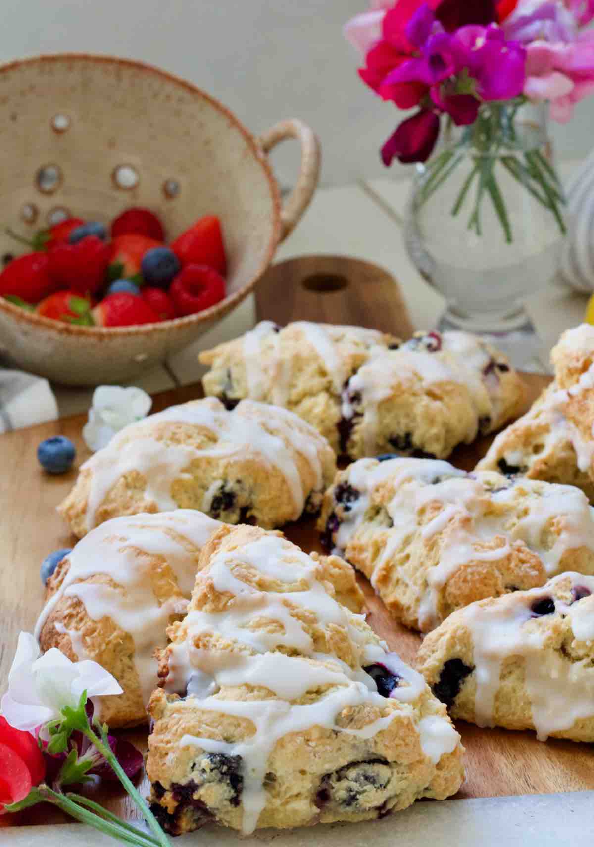 American style blueberry scones with lemon drizzle on a board.