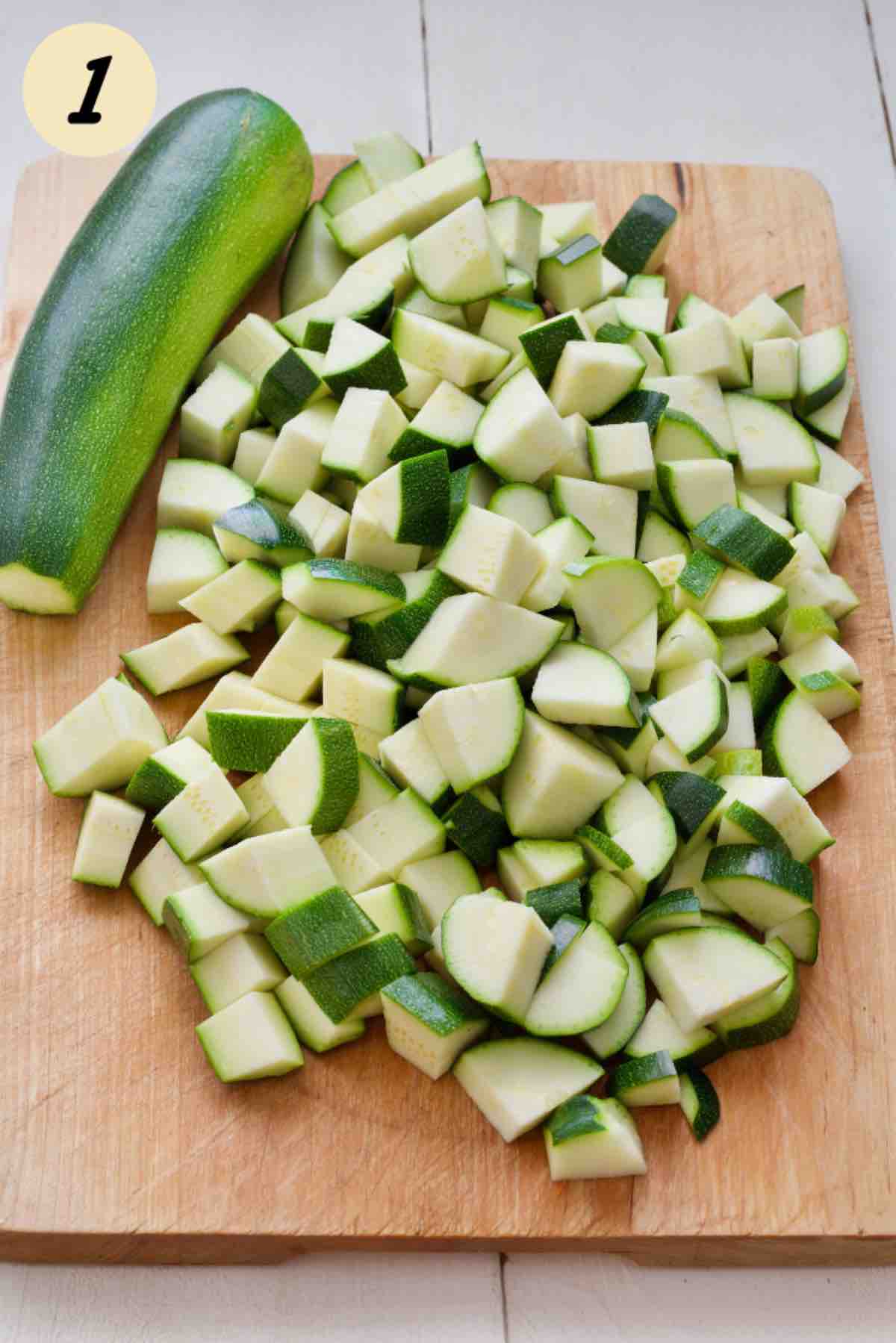 Chunks of courgettes on a wooden board.