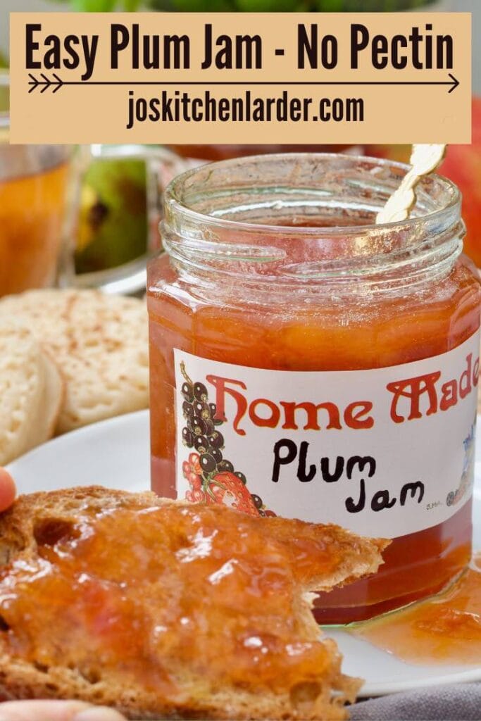 Open plum jam jar with piece of jam toast in front of it.
