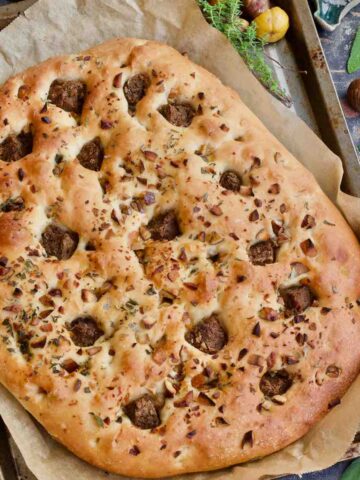 Close up of Christmas focaccia loaf on a baking tray.