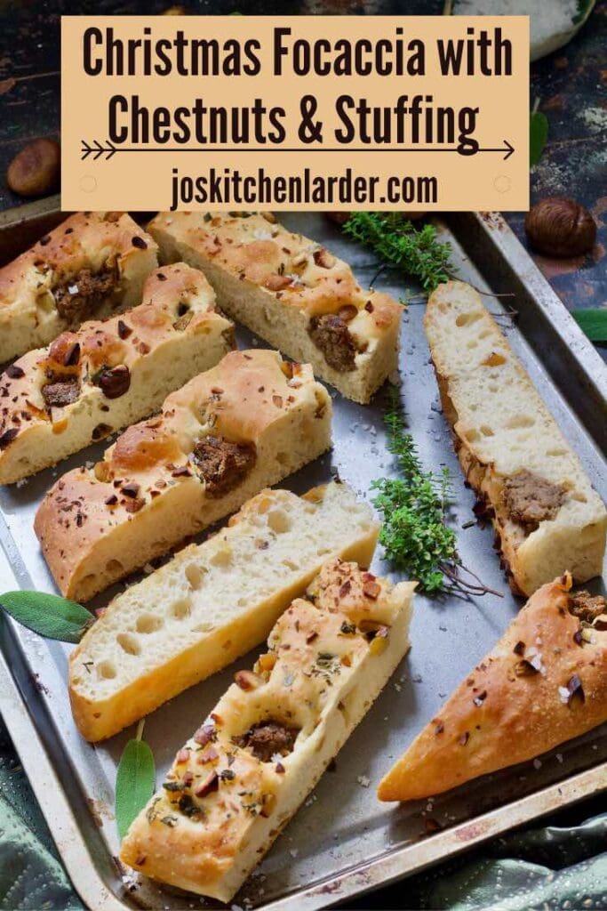 Baking tray full of focaccia slices, herbs and chestnuts.