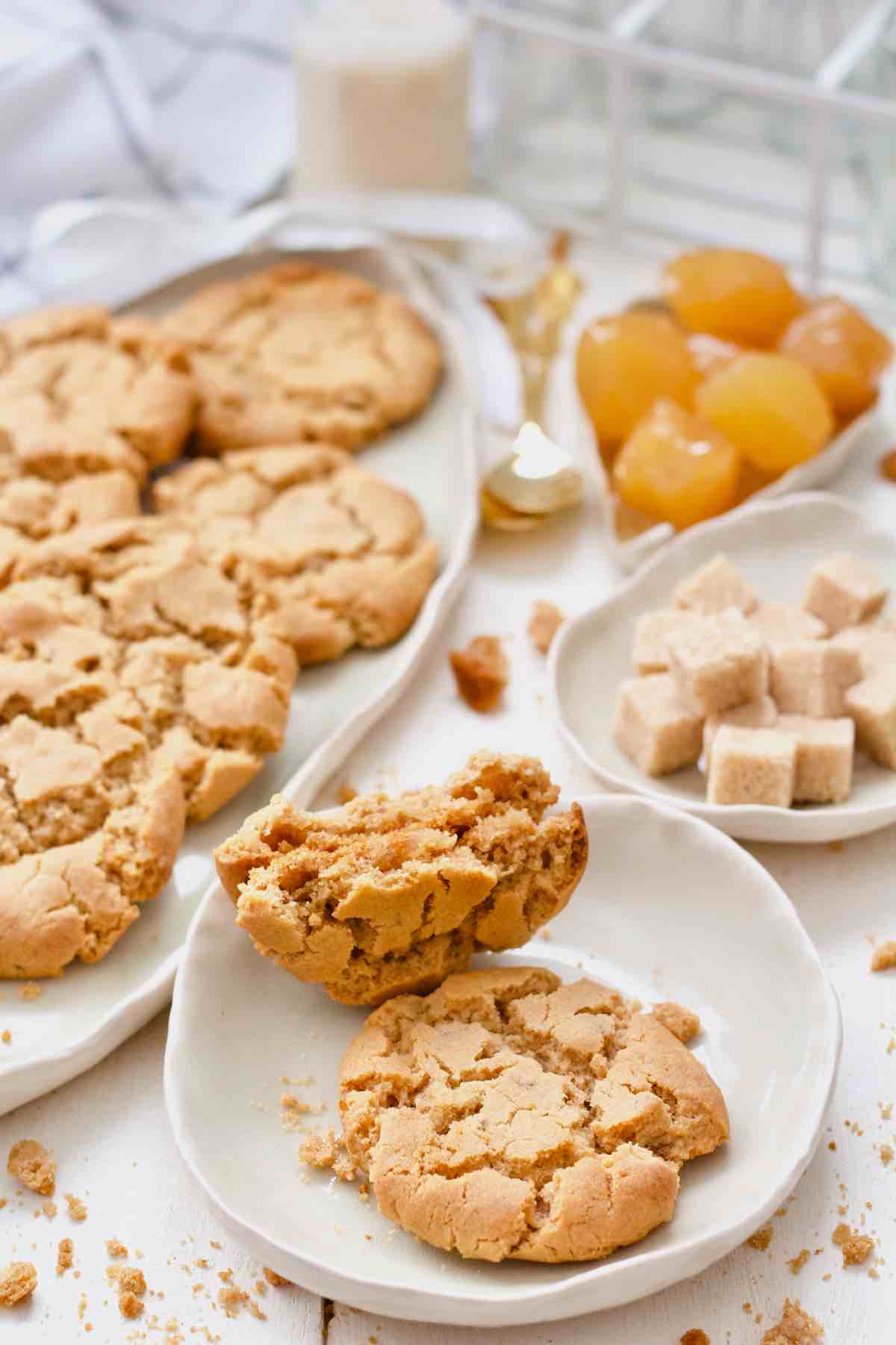 Ginger biscuit and one broken in half on a small plate.