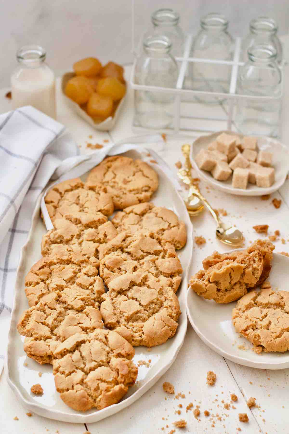 Platter with biscuits, plate with sugar cubes and small plate with more biscuits.