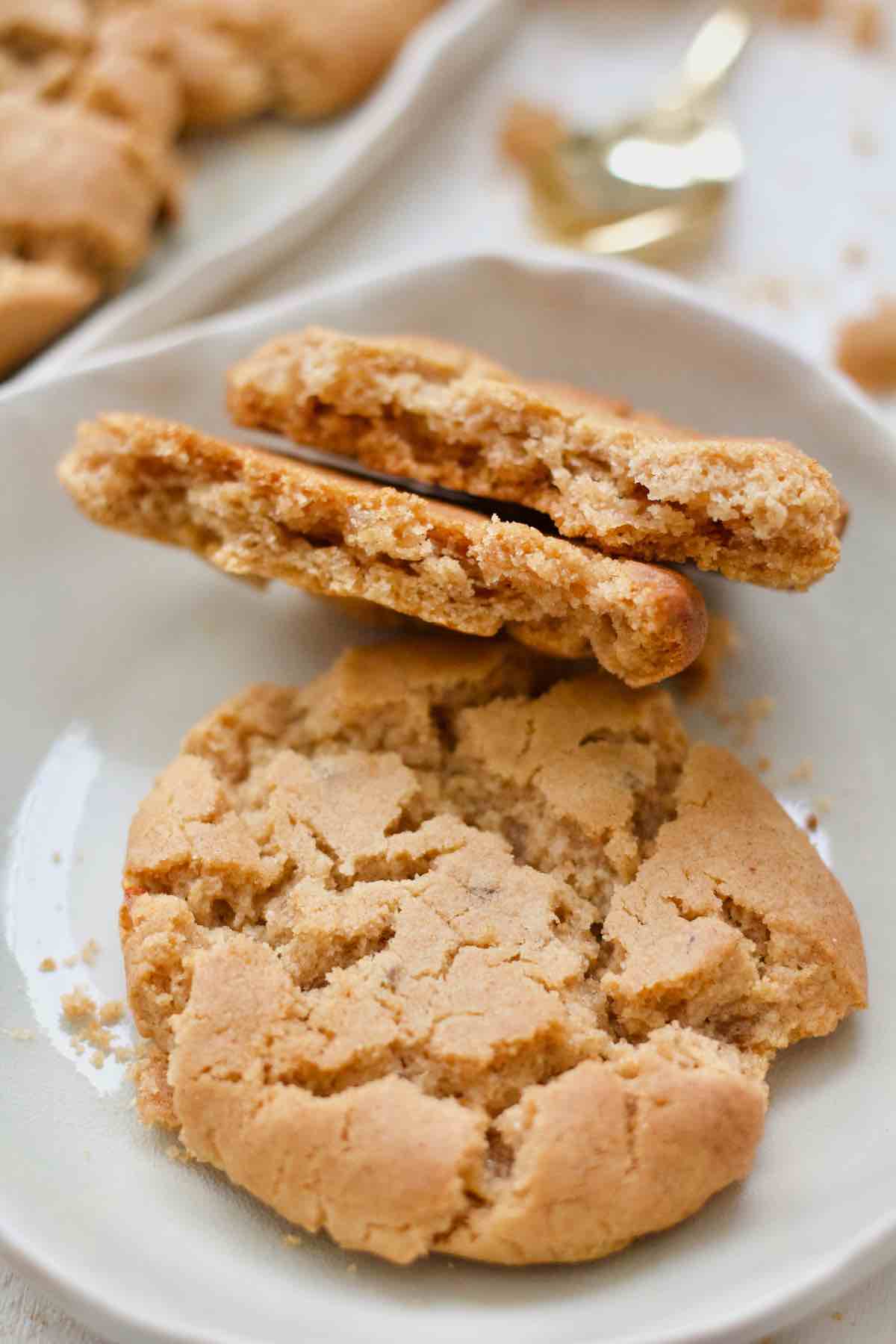 One whole ginger biscuits and one broken in half.