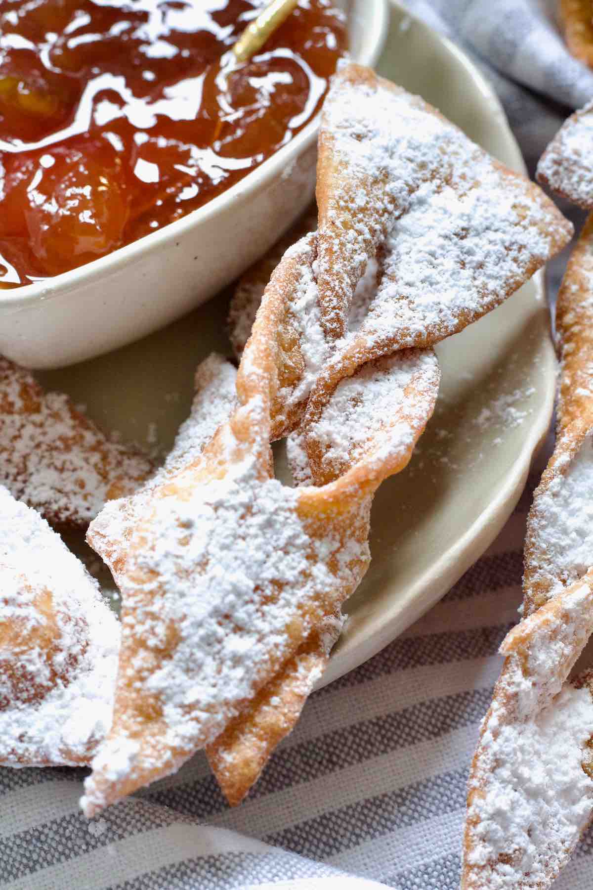 Close up of icing sugar dusted chrust.