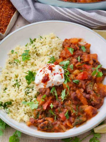 Close up of sweet potato and black bean stew served with quinoa.