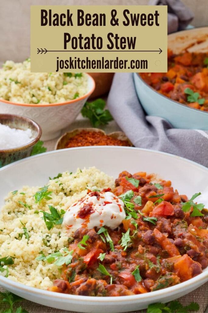 Plate of black bean and sweet potato stew with yogurt and harissa garnish.