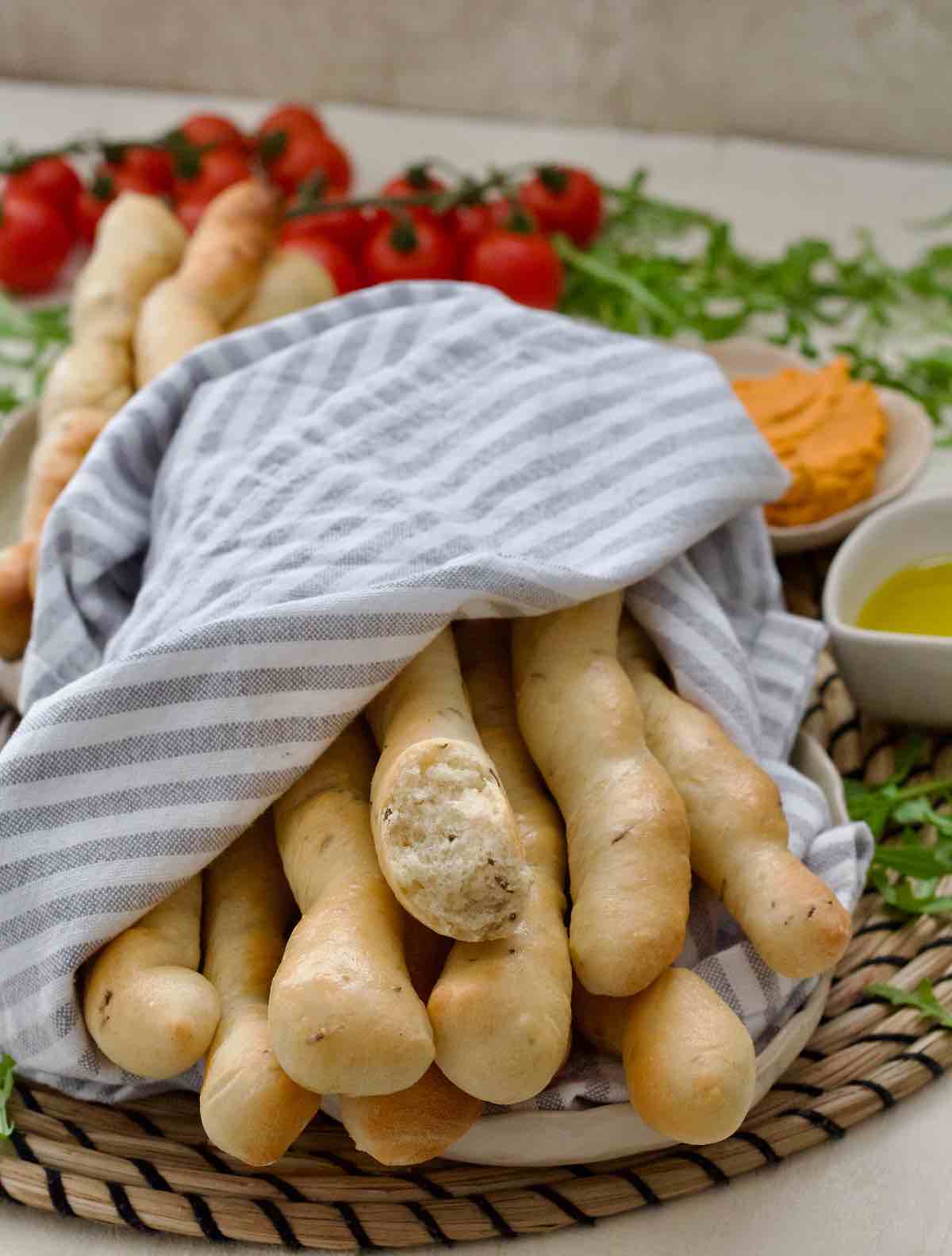 Bunch of breadsticks wrapped in a tea towel.