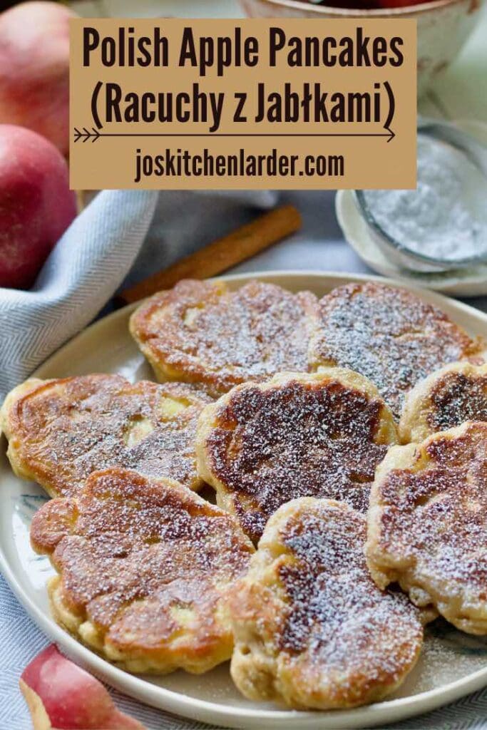 Close up of icing sugar dusted apple pancakes on a plate.