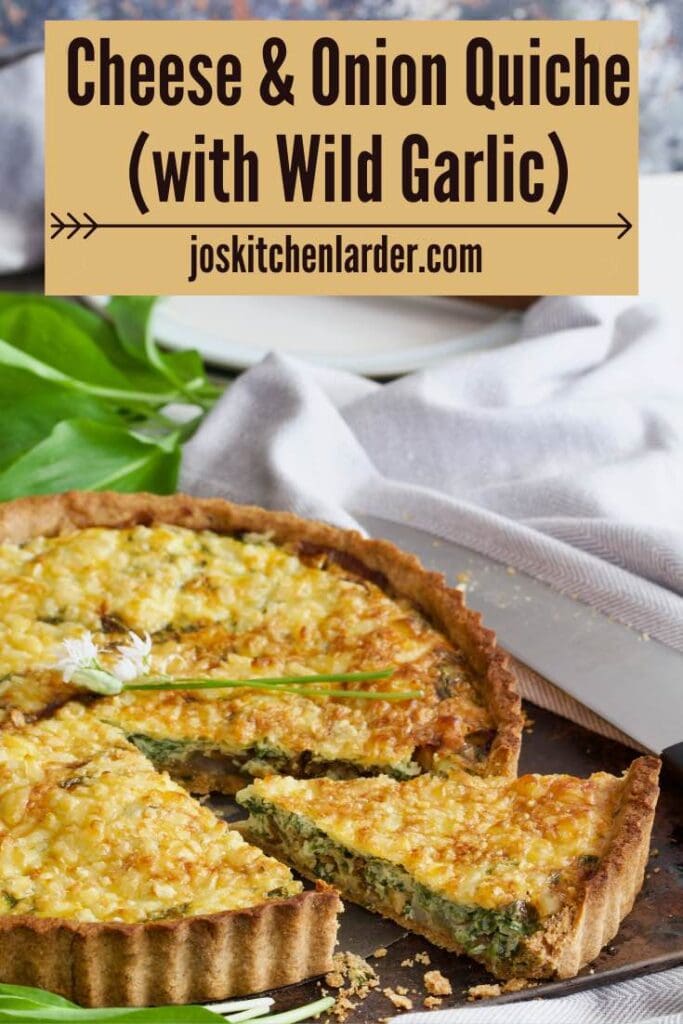 Wedge cut out of cheese and onion quiche, plates in the background.