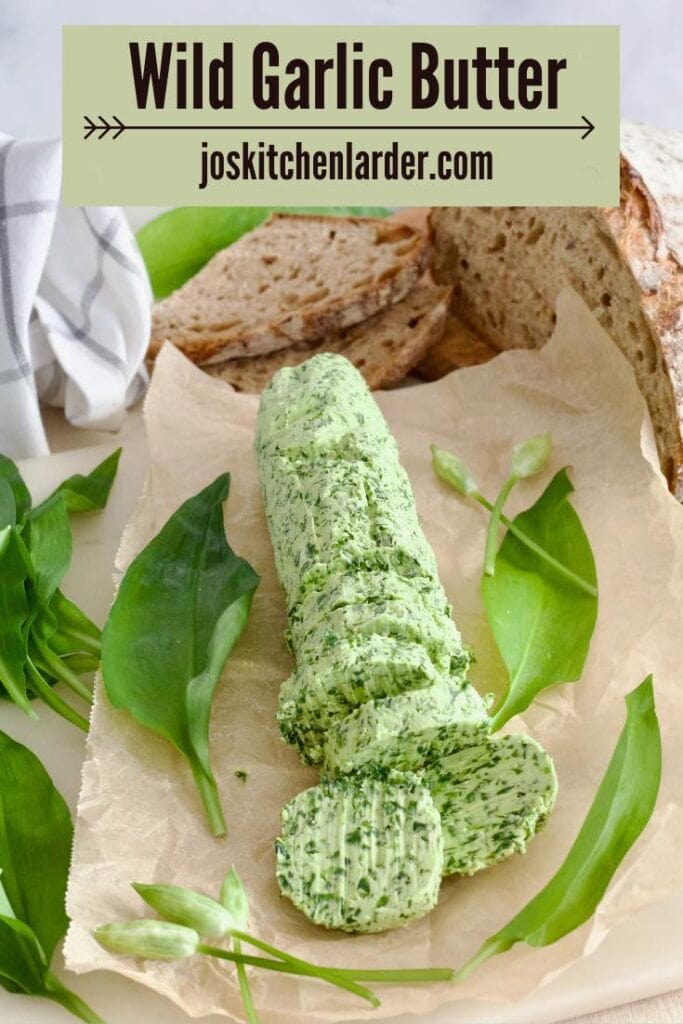 Log of wild garlic butter surrounded with garlic leaves and sourdough.