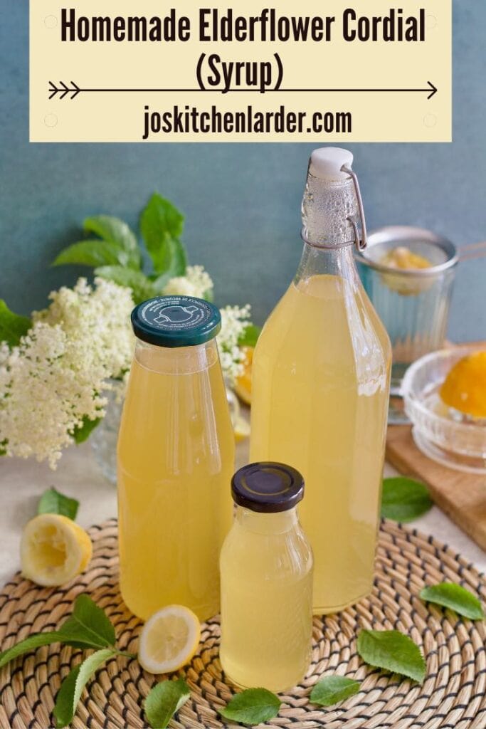 Three bottles of elderflower syrup on a mat.