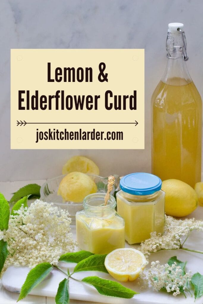 Spread consisting of elderflower cordial, two jars with curd, lemons and elderflowers.
