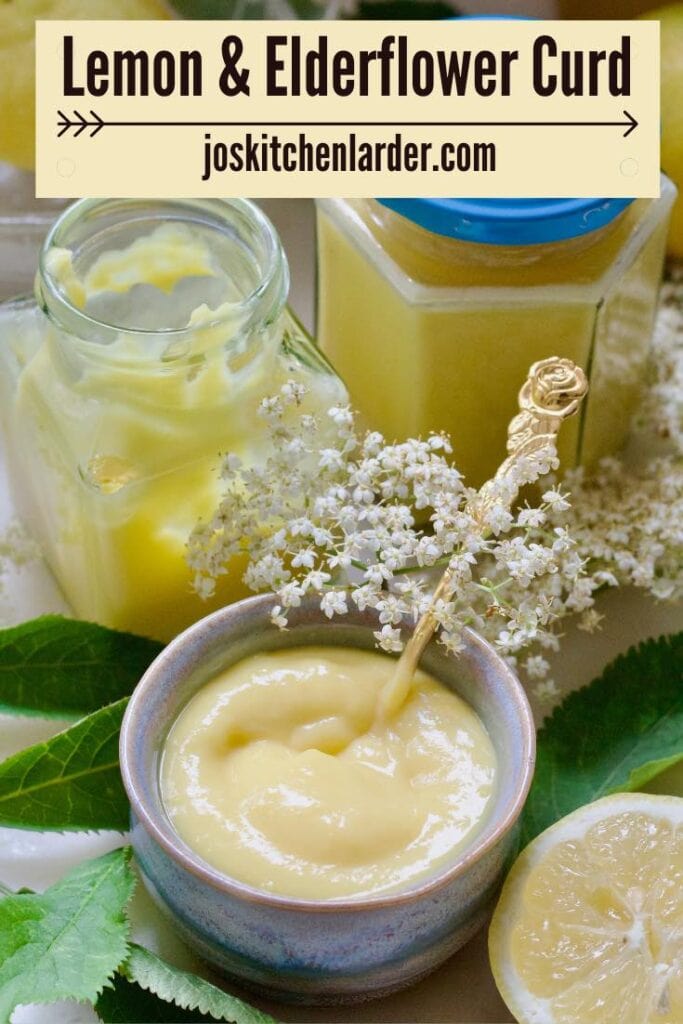 Bowl with curd, fresh elderflowers and two jars.