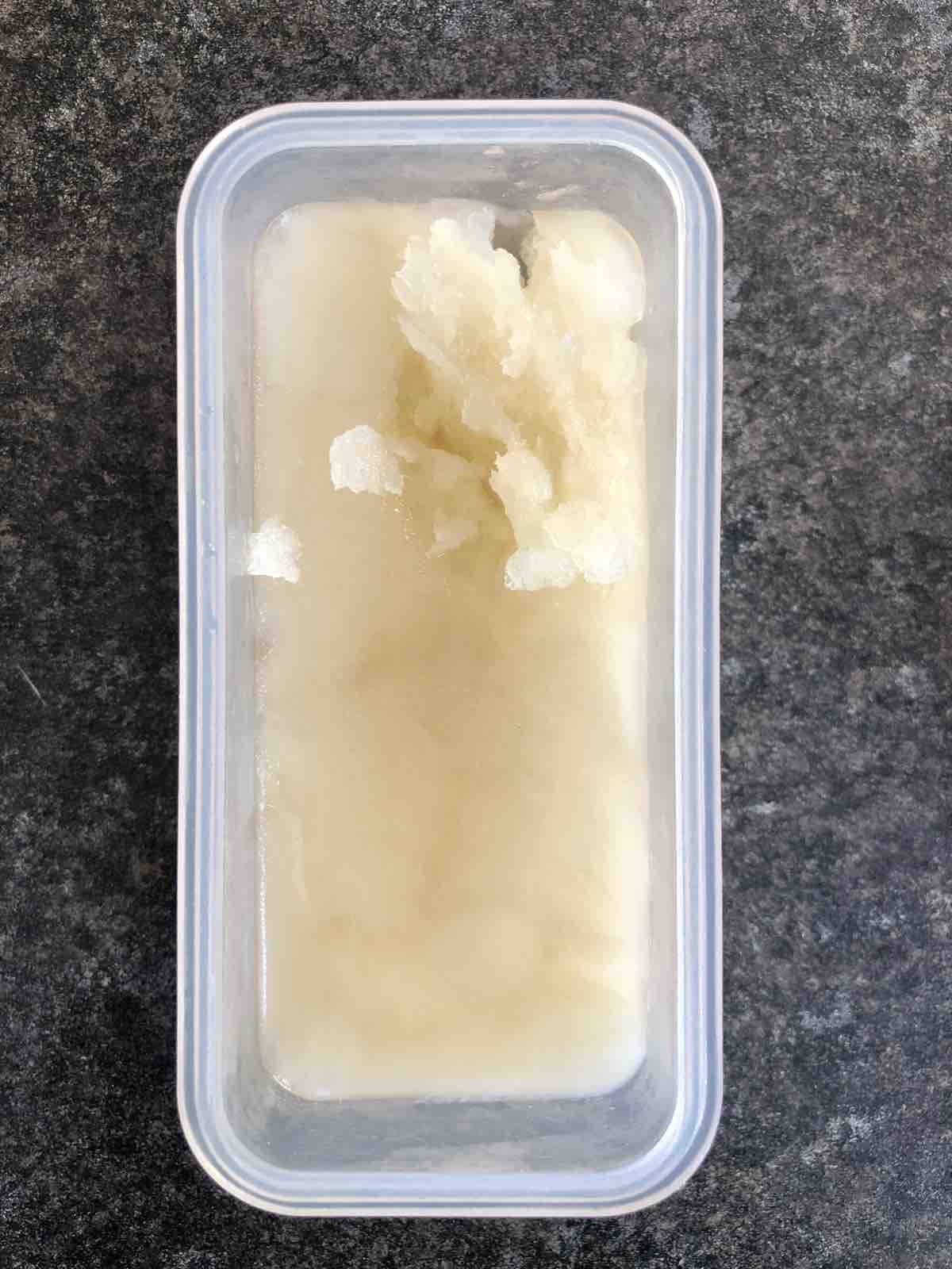 Frozen elderflower cordial in a tub.