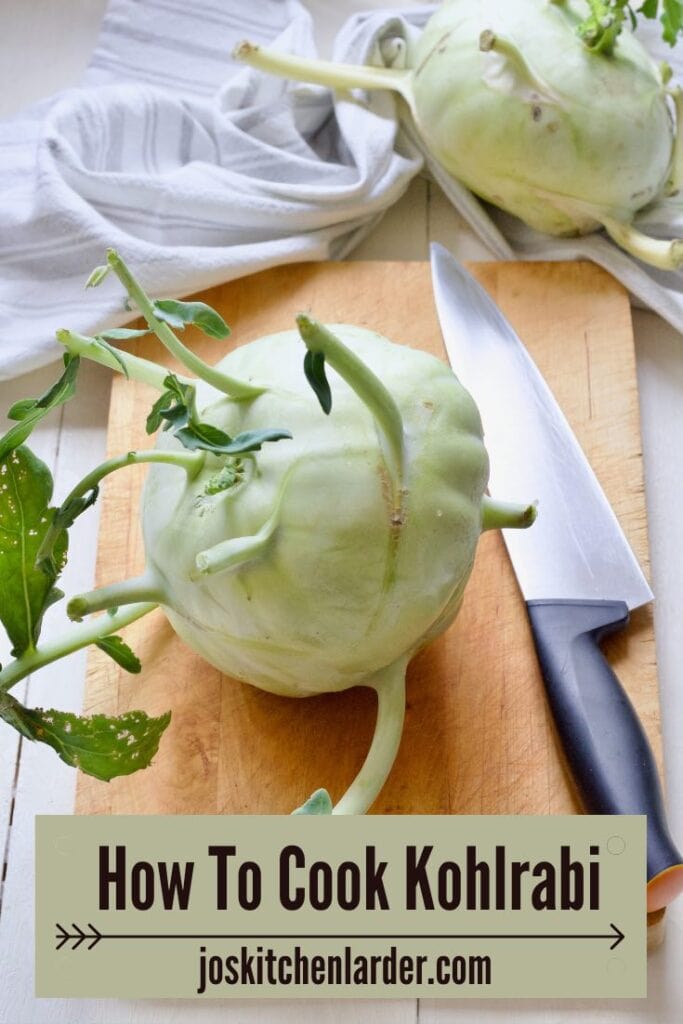 Kohlrabi bulb on a board with chef's knife next to it.