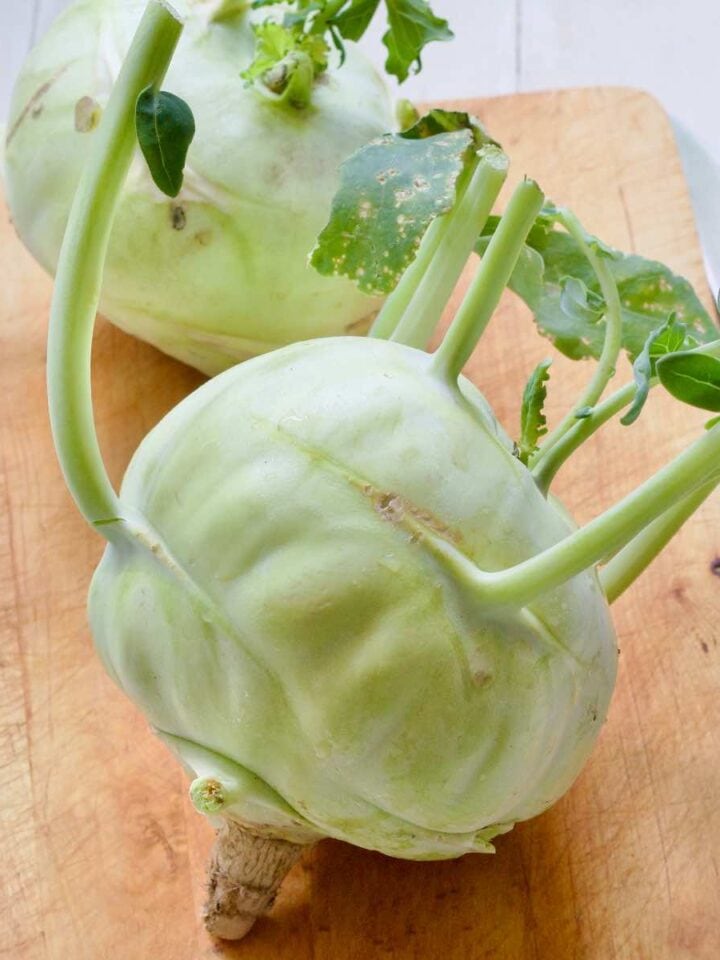Close up of kohlrabi on a wooden board.