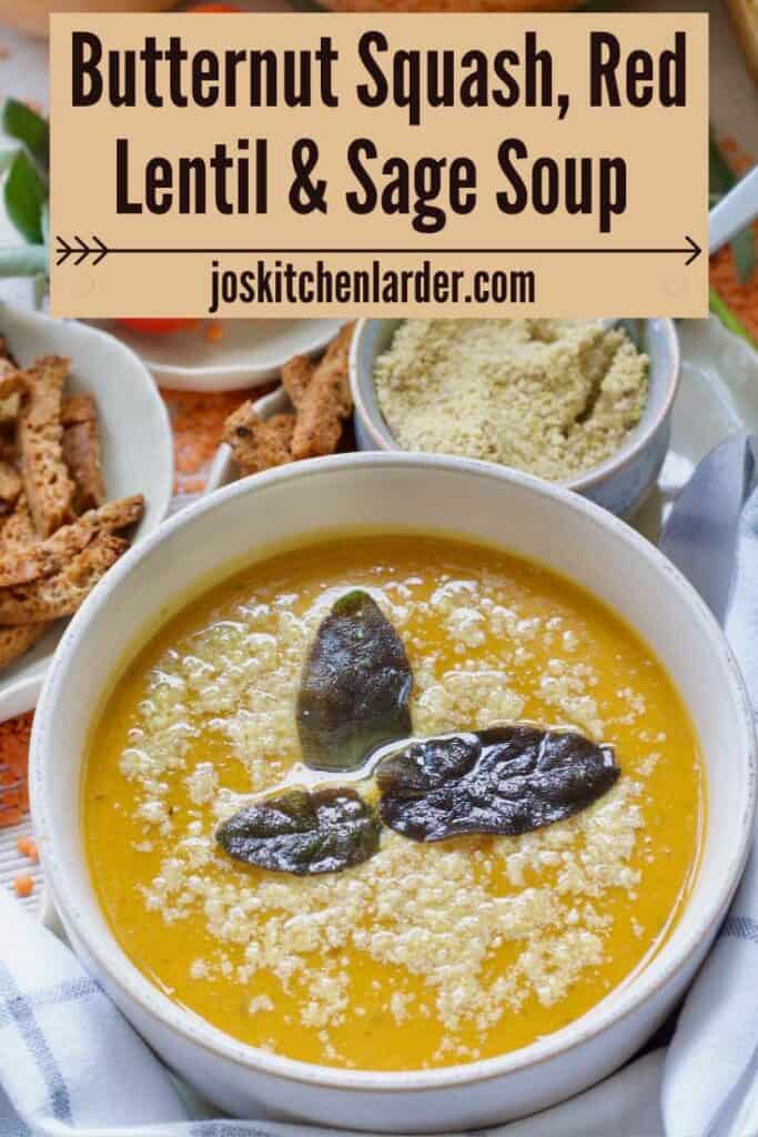 Bowl of butternut squash and red lentil soup with fried sage & parmesan garnish.