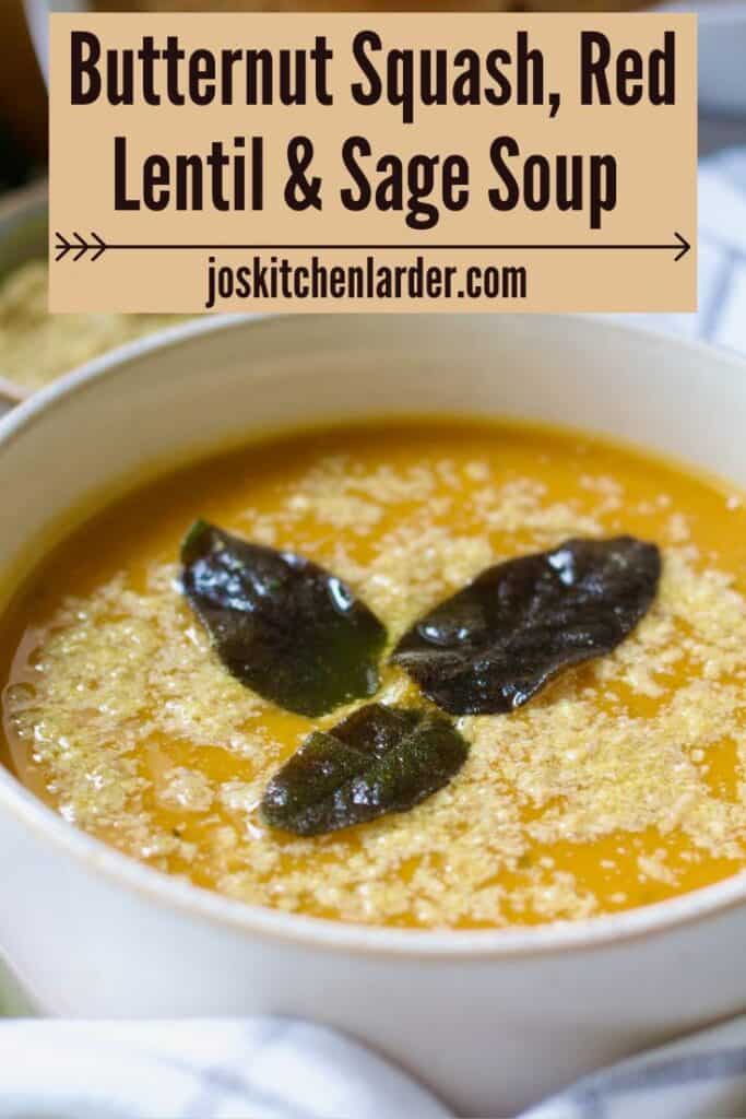 Close up of bowl of soup garnished with fried sage leaves.