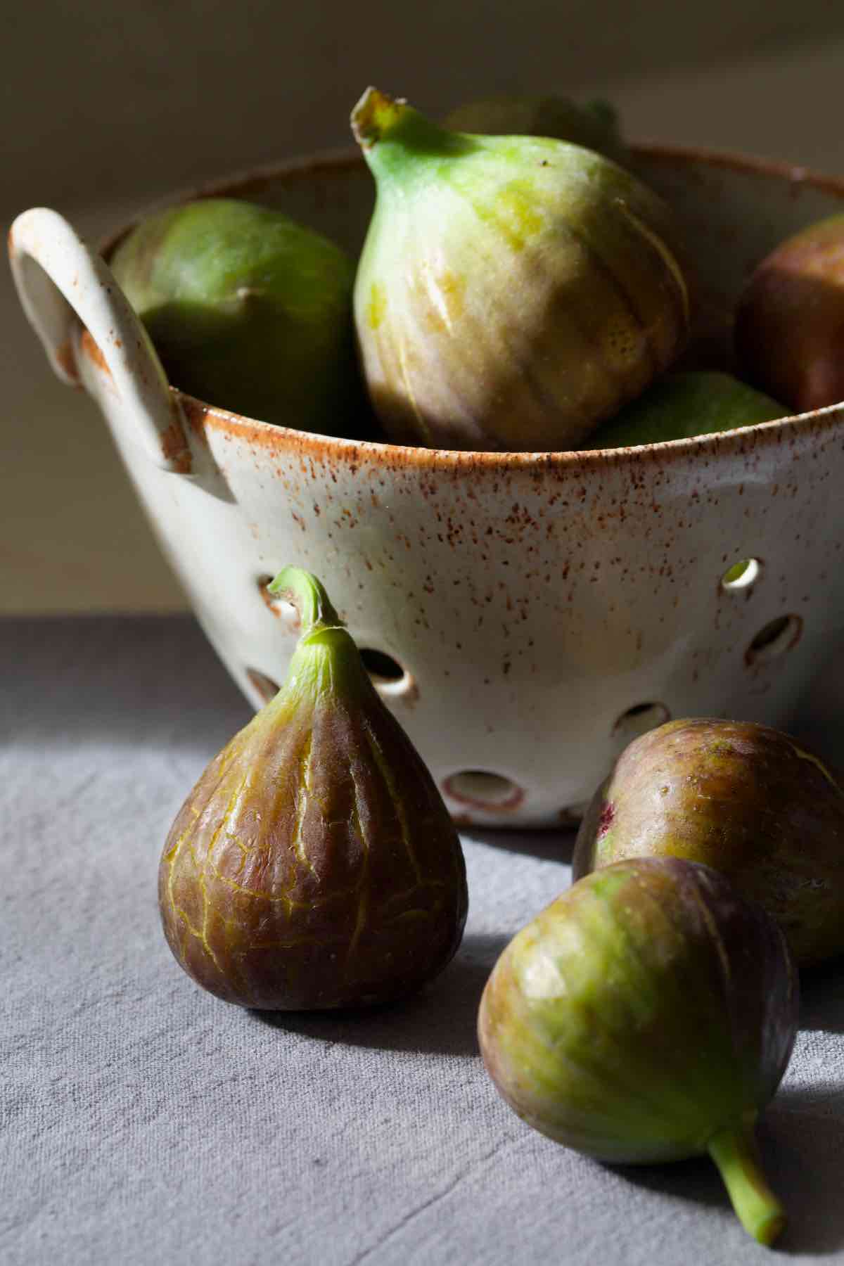 Figs presented in moody lighting.