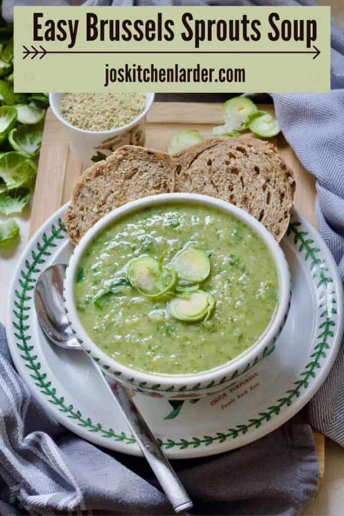 Bowl of Brussels sprouts soup garnished with shredded sprouts on a plate with granary bread slices.