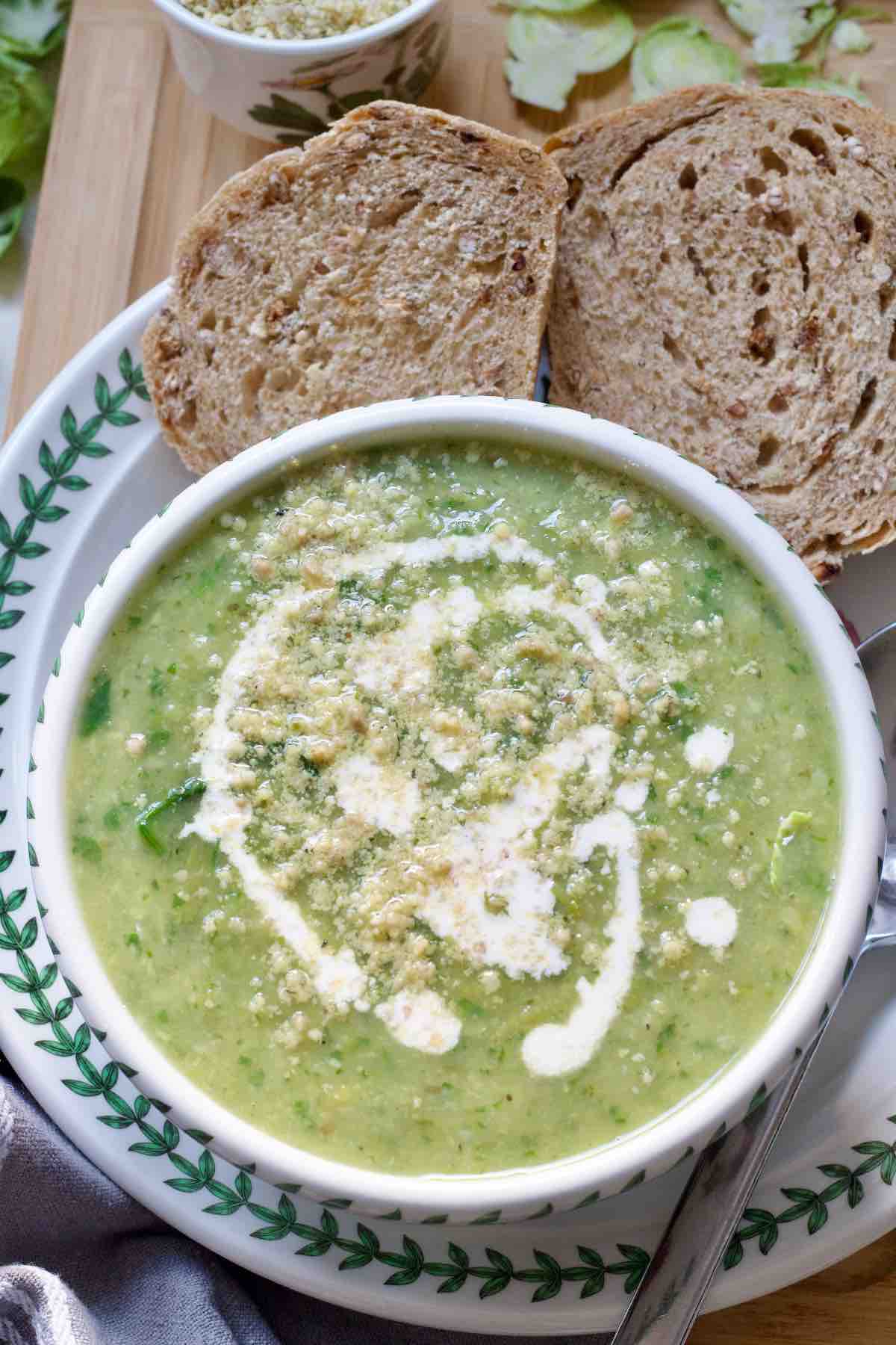 Bowl of Brussels sprouts soup with cream and vegan parmesan.