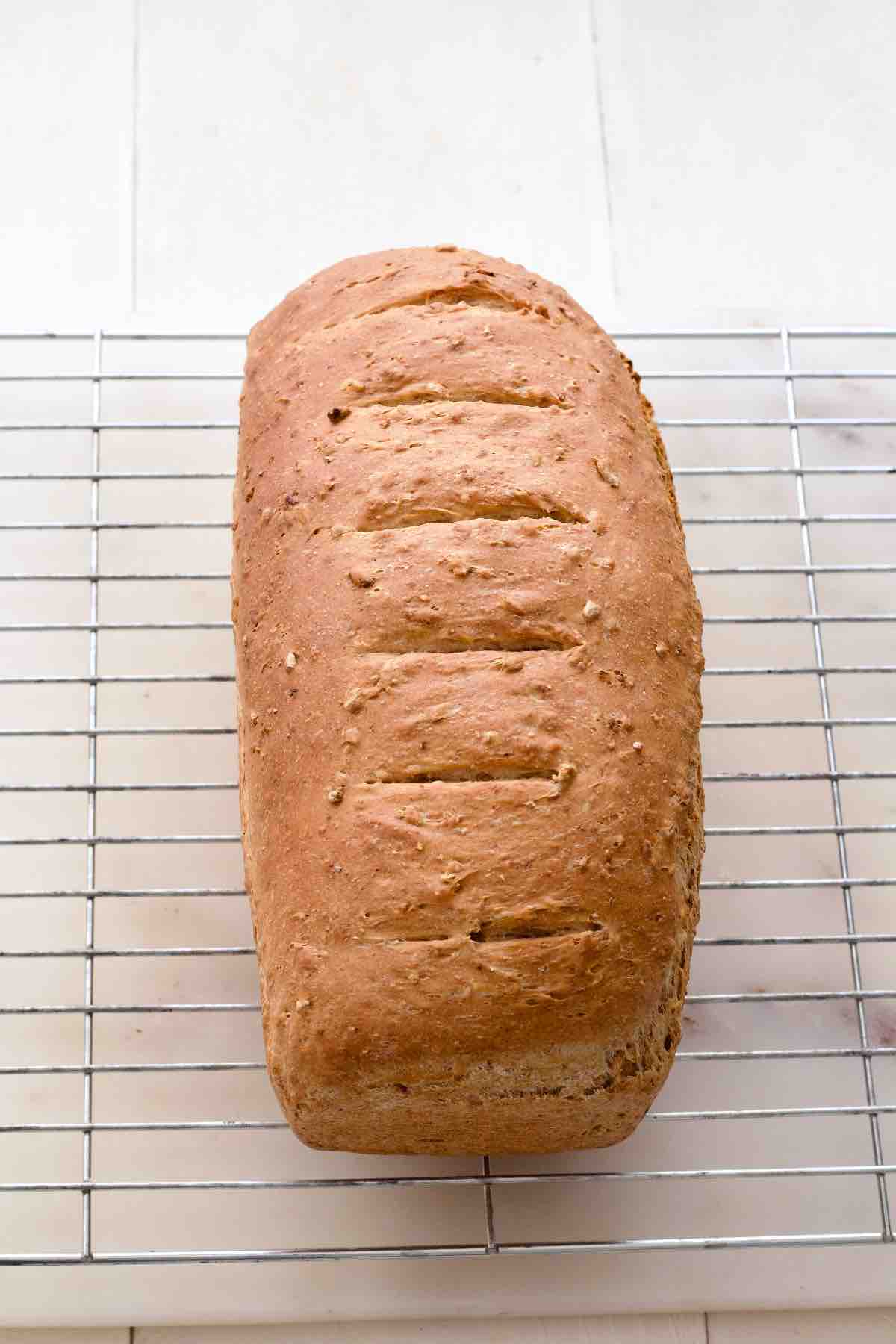 Granary bread resting on the cooling rack.